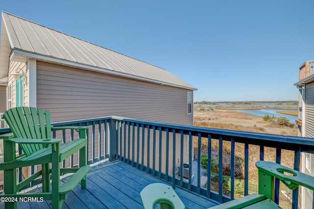 wooden terrace with a water view