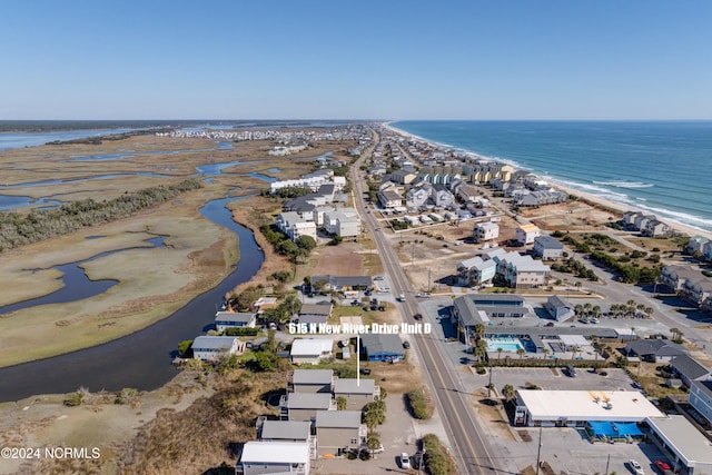 bird's eye view featuring a water view and a view of the beach