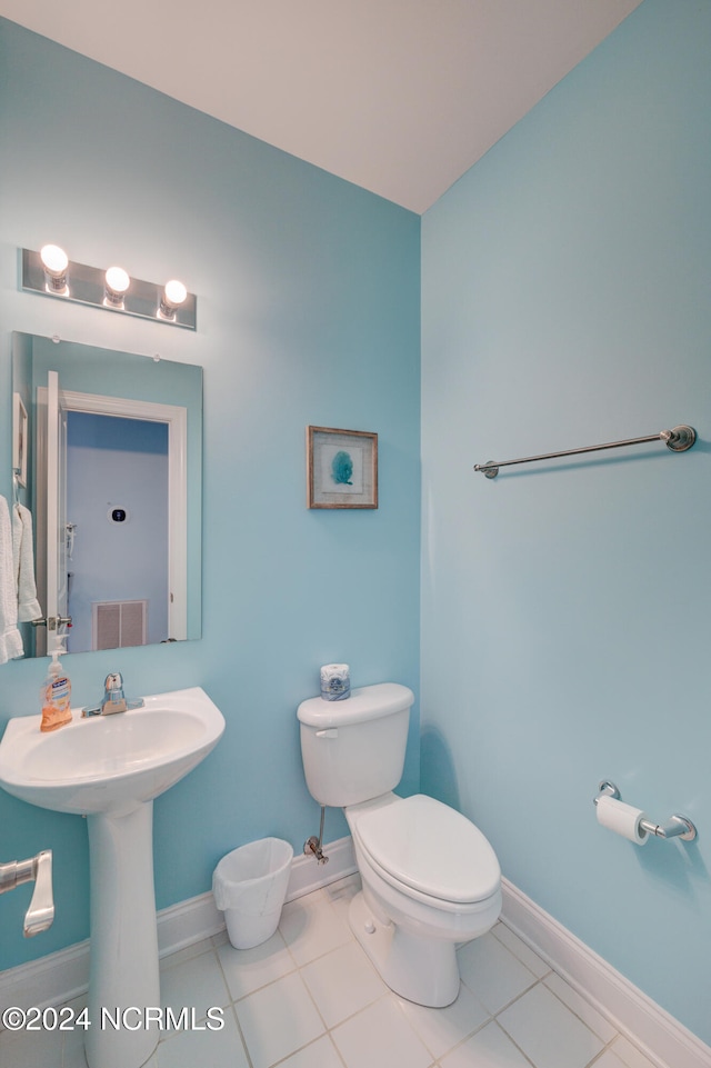 bathroom featuring toilet and tile patterned floors