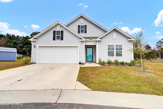 view of front of house with a garage and a front yard