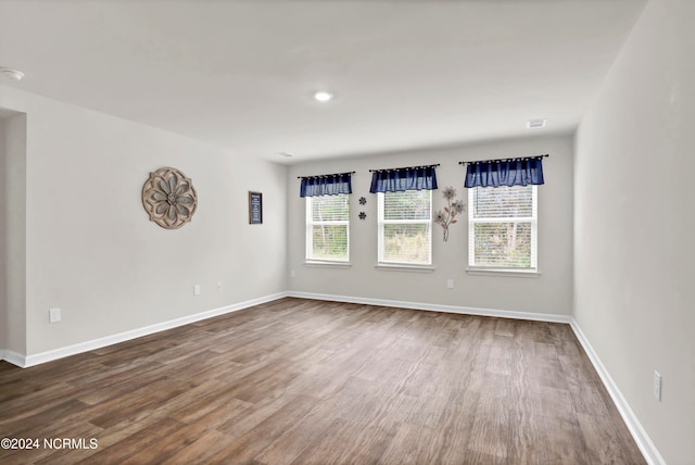 unfurnished room with hardwood / wood-style floors