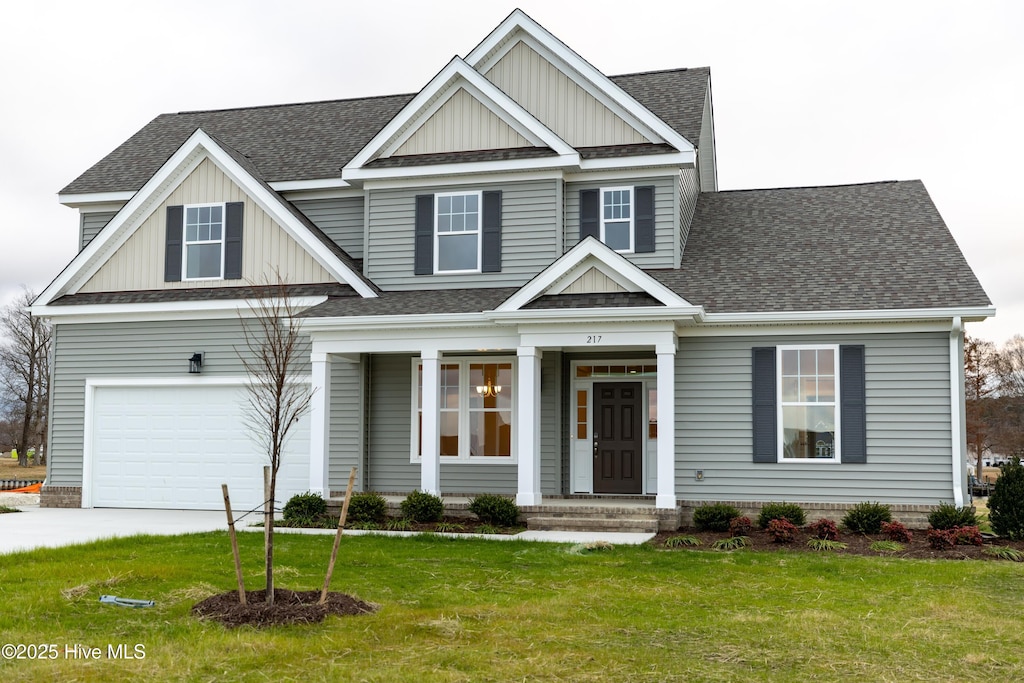 craftsman-style house featuring a garage and a front lawn