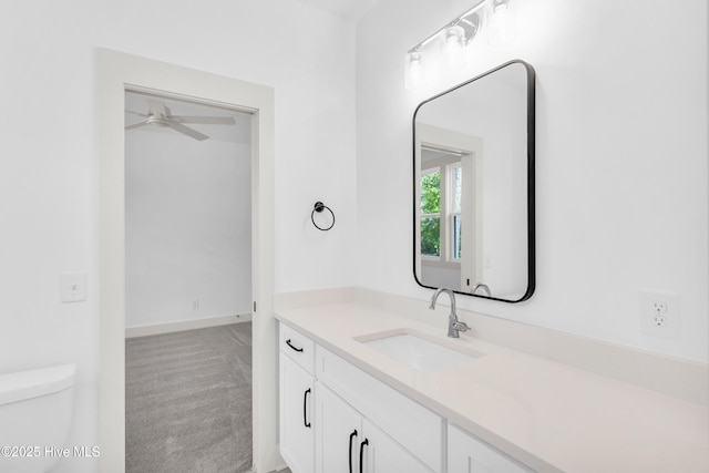 bathroom featuring vanity, ceiling fan, and toilet