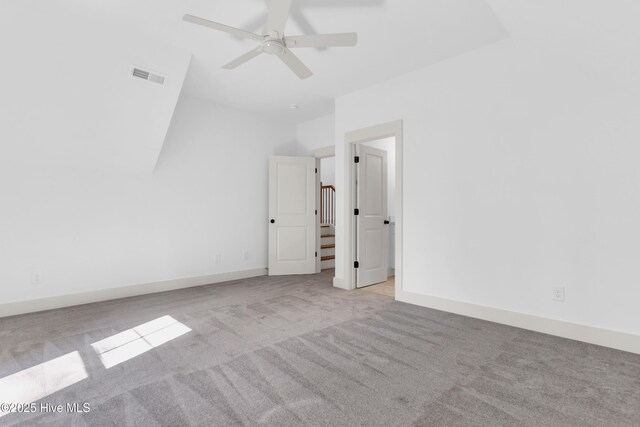carpeted spare room with ceiling fan and visible vents