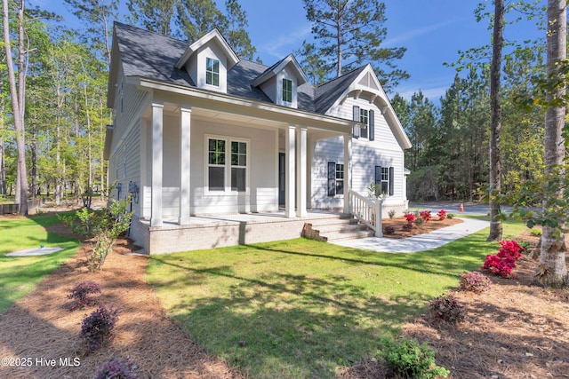 view of front of home with a front yard and covered porch