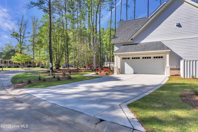 view of property exterior with concrete driveway, roof with shingles, a lawn, and a garage