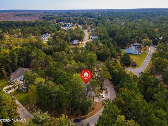 birds eye view of property featuring a view of trees