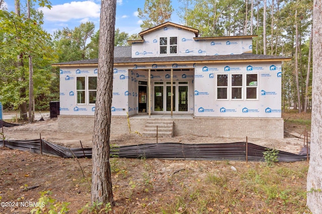 rear view of property with french doors