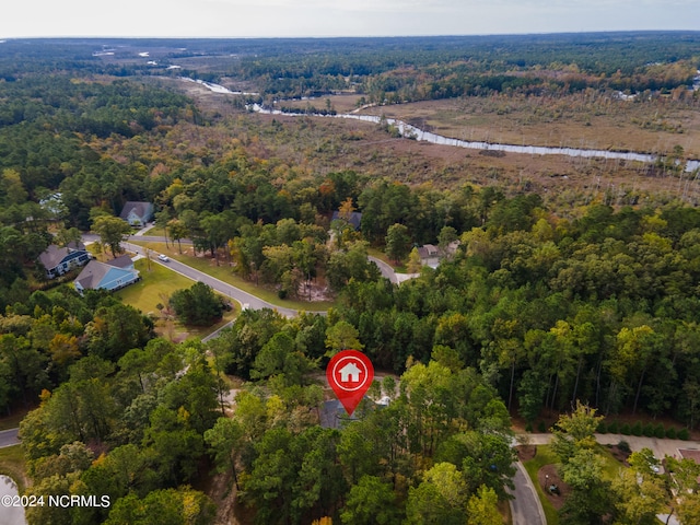 birds eye view of property featuring a view of trees