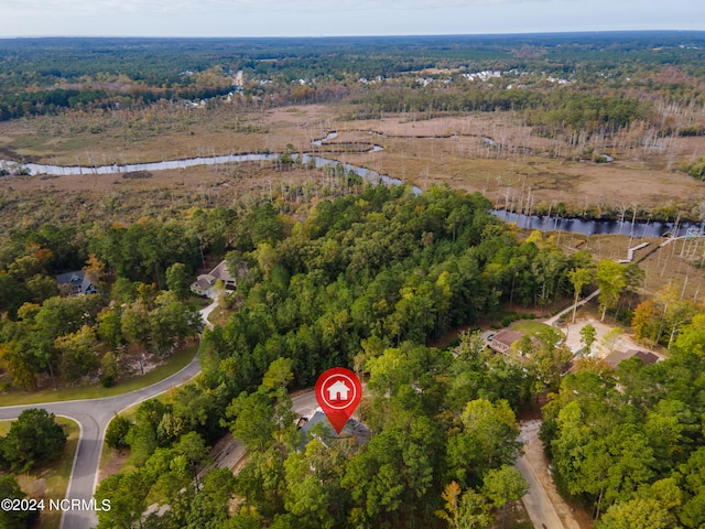 aerial view featuring a wooded view and a water view