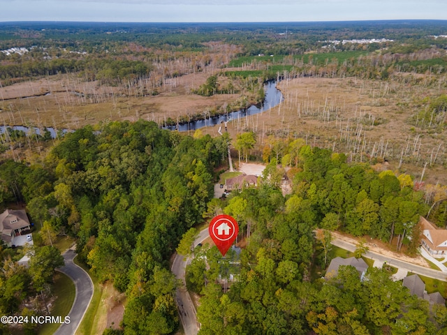 bird's eye view featuring a forest view and a water view