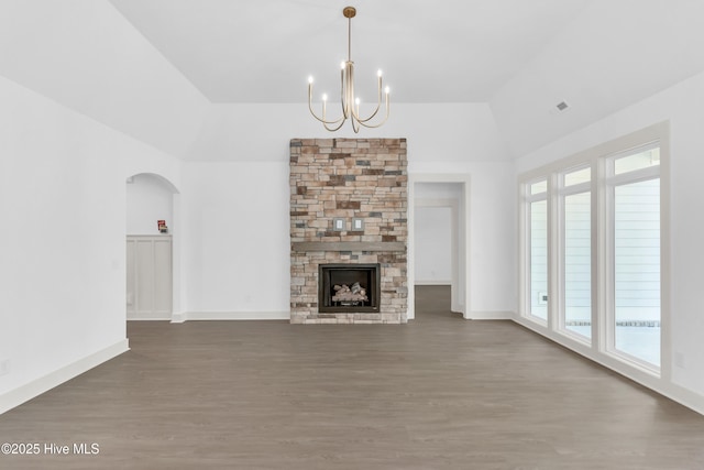 unfurnished living room featuring visible vents, baseboards, wood finished floors, and a notable chandelier