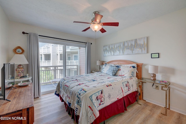 bedroom featuring light hardwood / wood-style floors, a textured ceiling, access to outside, and ceiling fan