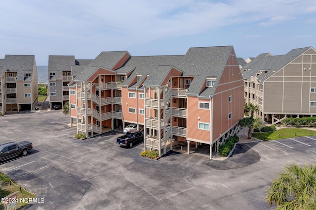 1000 Caswell Beach Rd Unit 1111, Oak Island, NC 28465 - view of apartment building / complex featuring uncovered parking