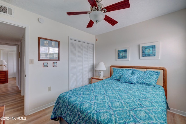 bedroom featuring a closet, ceiling fan, and light hardwood / wood-style flooring