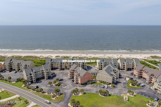 bird's eye view featuring a view of the beach and a water view