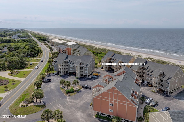 bird's eye view featuring a view of the beach and a water view