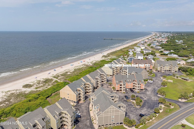 birds eye view of property featuring a water view and a beach view