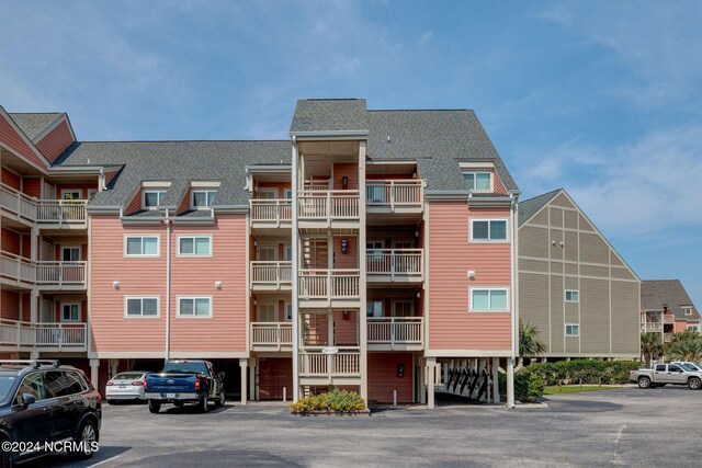 1000 Caswell Beach Rd Unit 1111, Oak Island, NC 28465 - view of property with uncovered parking