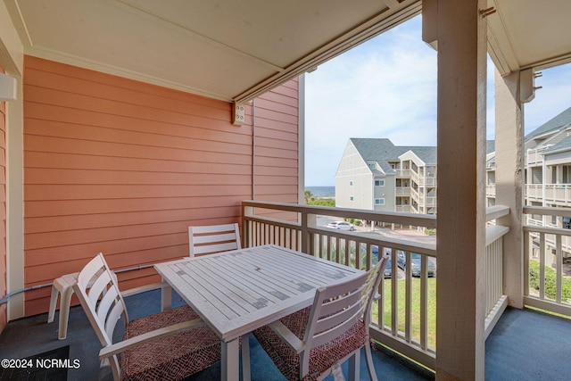 1000 Caswell Beach Rd Unit 1111, Oak Island, NC 28465 - balcony featuring outdoor dining space and a residential view