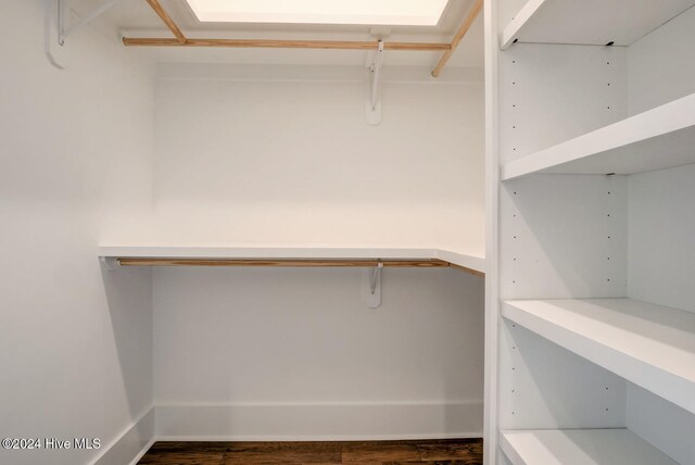 walk in closet featuring dark floors and visible vents