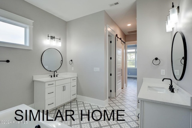 187 Spicer Lake Dr, Holly Ridge, NC 28445 - full bath featuring a sink, baseboards, visible vents, and two vanities
