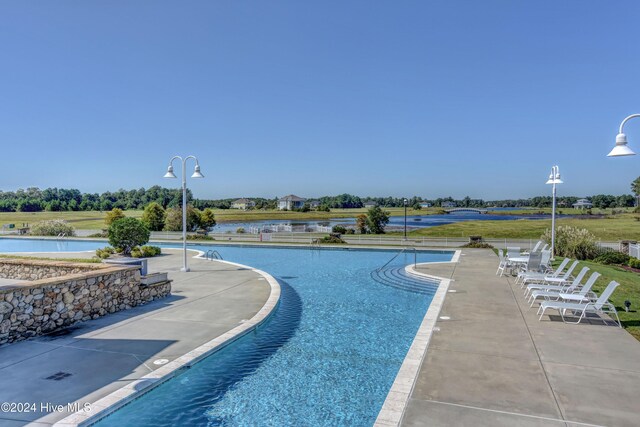 view of swimming pool with a patio and french doors