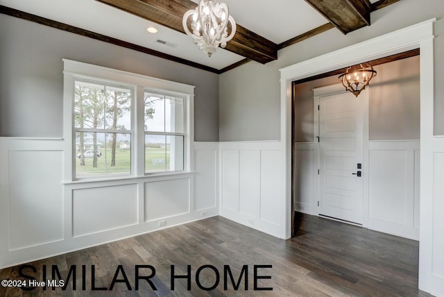 unfurnished dining area with visible vents, dark wood-style floors, a wainscoted wall, an inviting chandelier, and beam ceiling