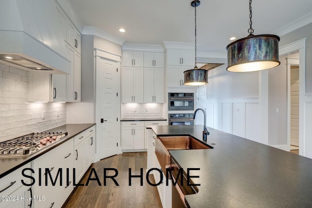 kitchen featuring dark wood-type flooring, white cabinets, custom range hood, dark countertops, and stainless steel gas stovetop