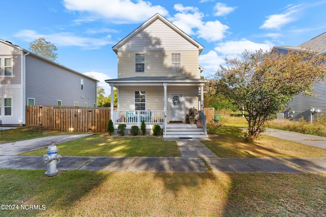 front facade featuring a front lawn and a porch