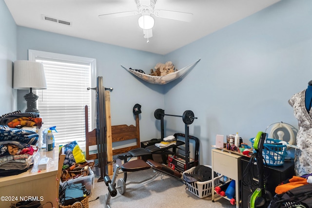 workout room with carpet flooring and ceiling fan