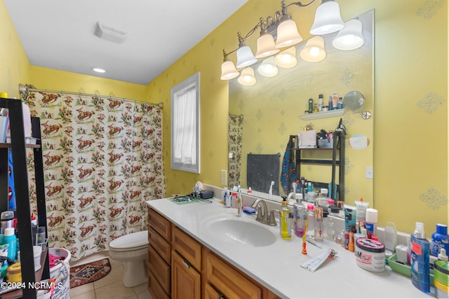 bathroom featuring vanity, toilet, walk in shower, and tile patterned flooring