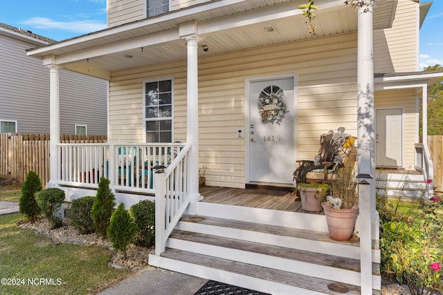 property entrance with covered porch