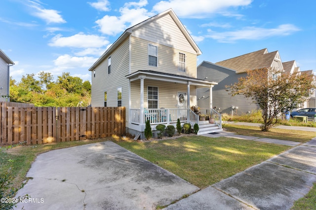 view of front facade with a front yard and covered porch