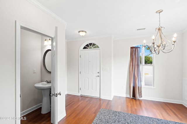 foyer entrance featuring crown molding and wood-type flooring