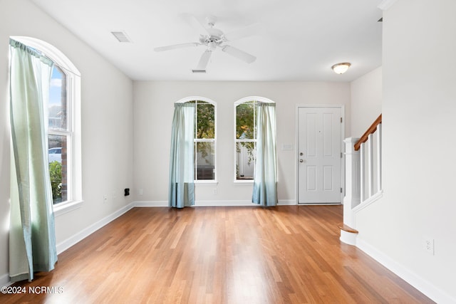 foyer with light hardwood / wood-style flooring and ceiling fan