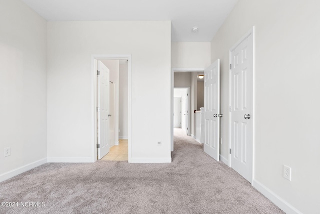 unfurnished bedroom with light colored carpet