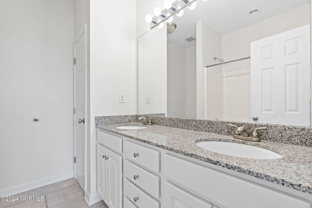 bathroom with vanity and tile patterned flooring