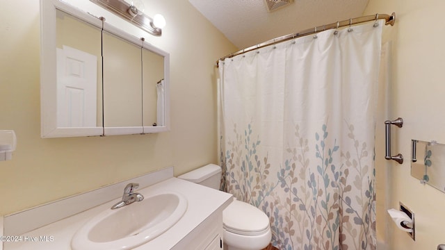 bathroom with toilet, vanity, a textured ceiling, and curtained shower