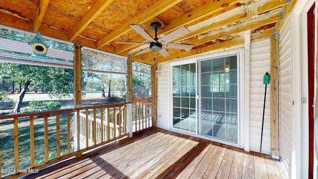 unfurnished sunroom with ceiling fan