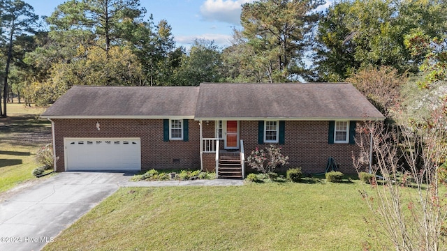 ranch-style house featuring a garage and a front lawn