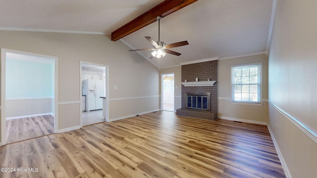 unfurnished living room with a brick fireplace, light hardwood / wood-style floors, ceiling fan, and lofted ceiling with beams