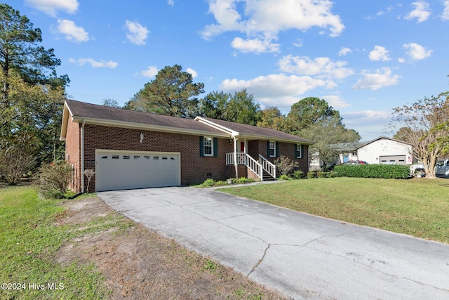 ranch-style home with a garage and a front yard