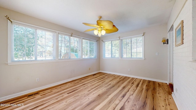 spare room featuring light hardwood / wood-style floors and ceiling fan