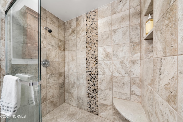 bathroom featuring a shower with door