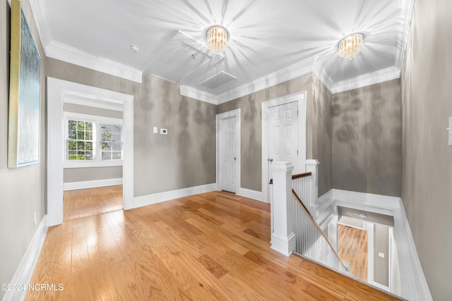 interior space featuring a chandelier, light wood-type flooring, and ornamental molding