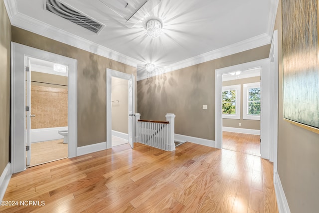 unfurnished room featuring crown molding and light hardwood / wood-style flooring