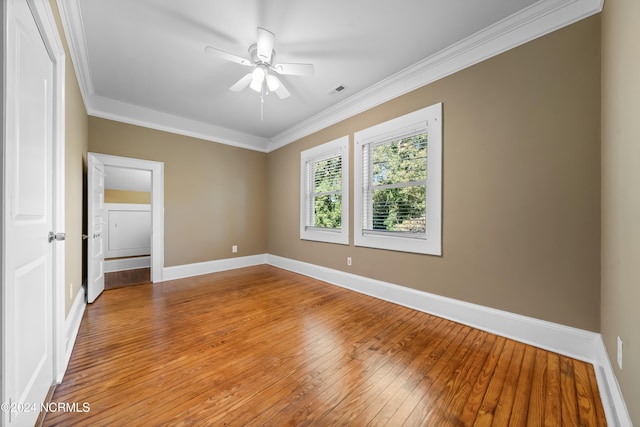 spare room featuring crown molding, ceiling fan, and light wood-type flooring