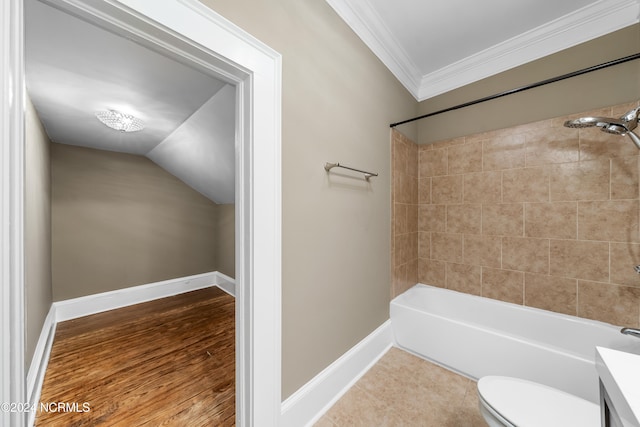 full bathroom with tiled shower / bath, hardwood / wood-style floors, vaulted ceiling, toilet, and ornamental molding