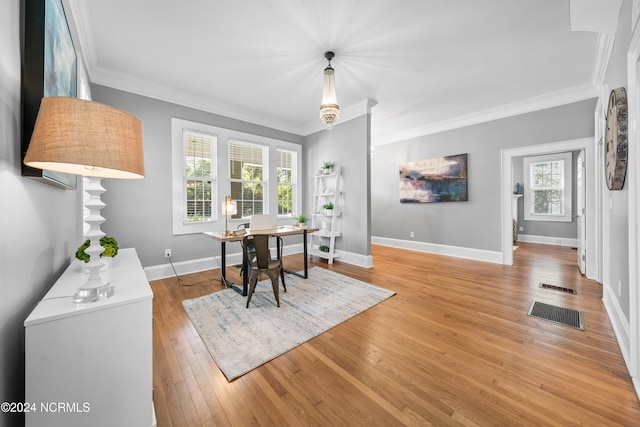 dining area with light wood-type flooring and crown molding